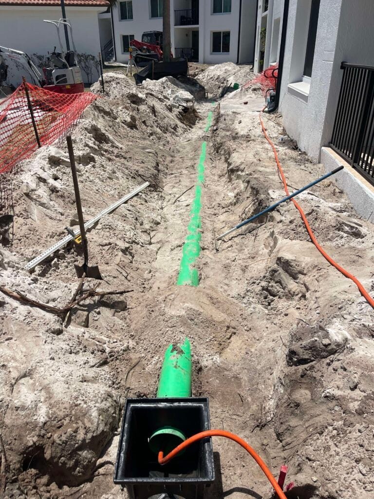Thum Co excavator installing drainage pipes Palm Beach County