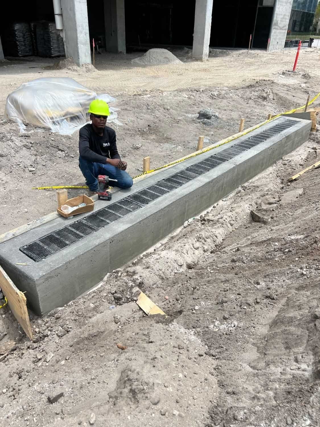 Finished concrete-encased trench drain with a heavy-duty ductile iron grate in West Palm Beach, FL